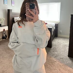 white and orange crewneck